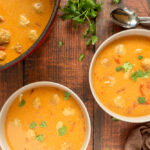 Overhead shot of peanut soup in bowls.