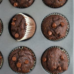 Skinny Double Chocolate Muffins in pan with one on side.