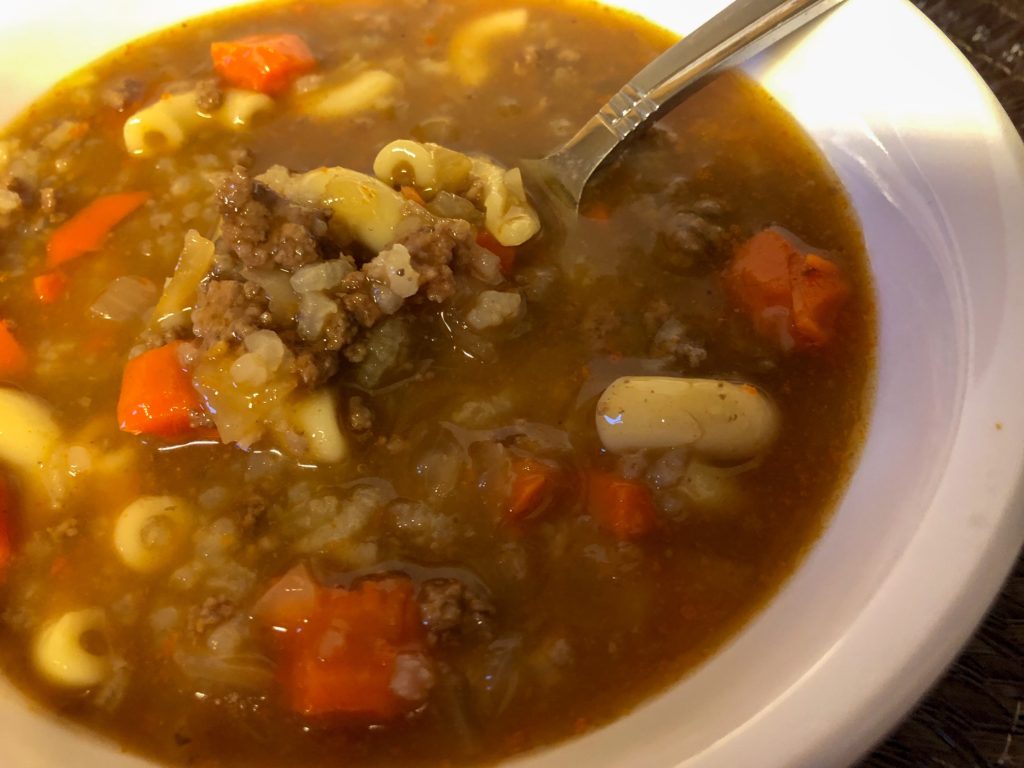 hamburger soup in bowl with spoon