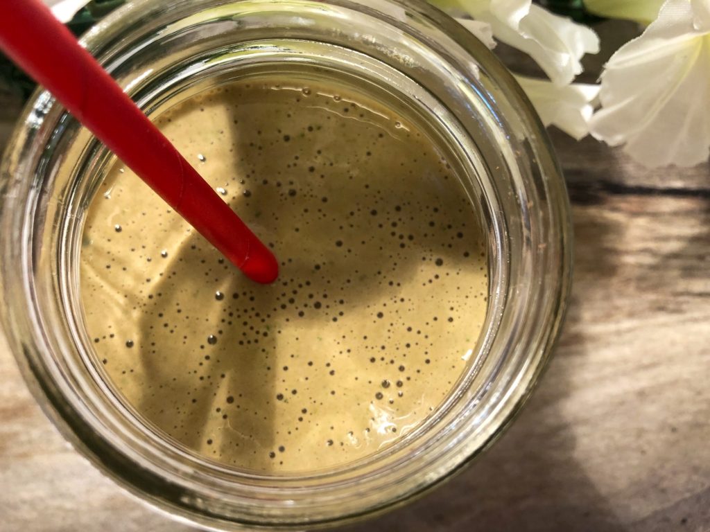 chocolate protein green smoothie with artificial flowers