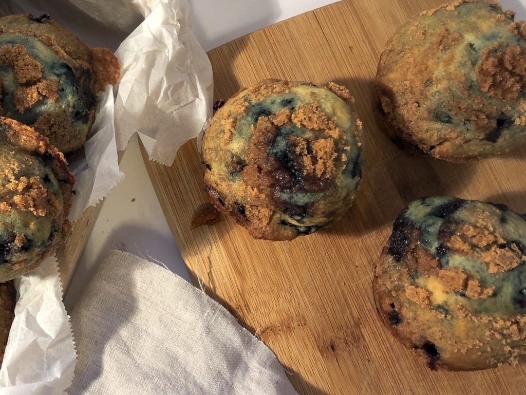 blueberry streusel muffins on cutting board