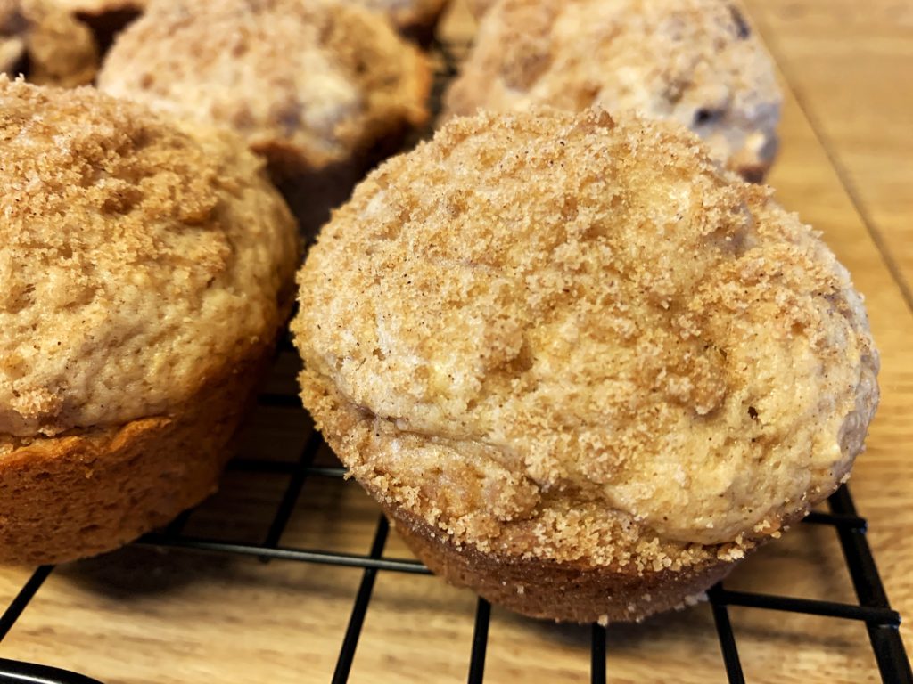 cinnamon raisin muffins with streusel on wire rack