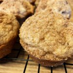 cinnamon raisin muffins with streusel on wire rack