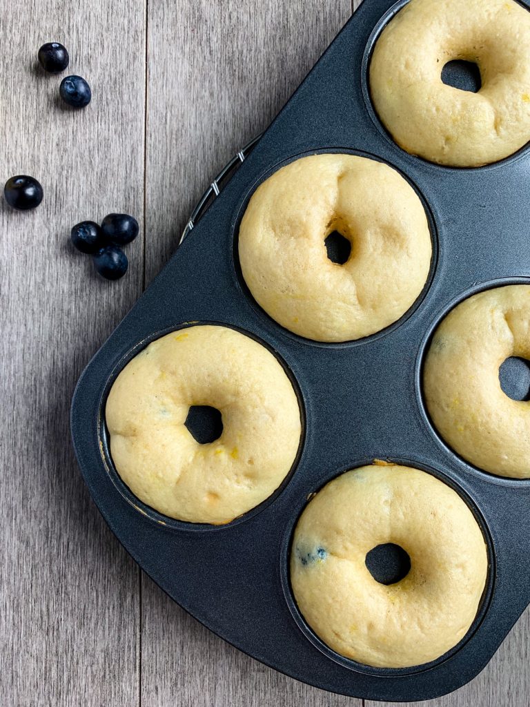 lemon glazed blueberry donuts in pan