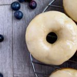 lemon glazed blueberry donuts on wire rack