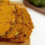 Sliced Pumpkin Bread with pepitas on top.