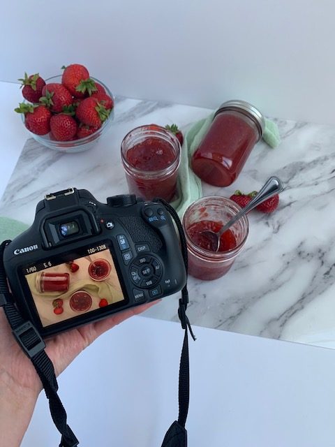 practicing DSLR camera on strawberry jam