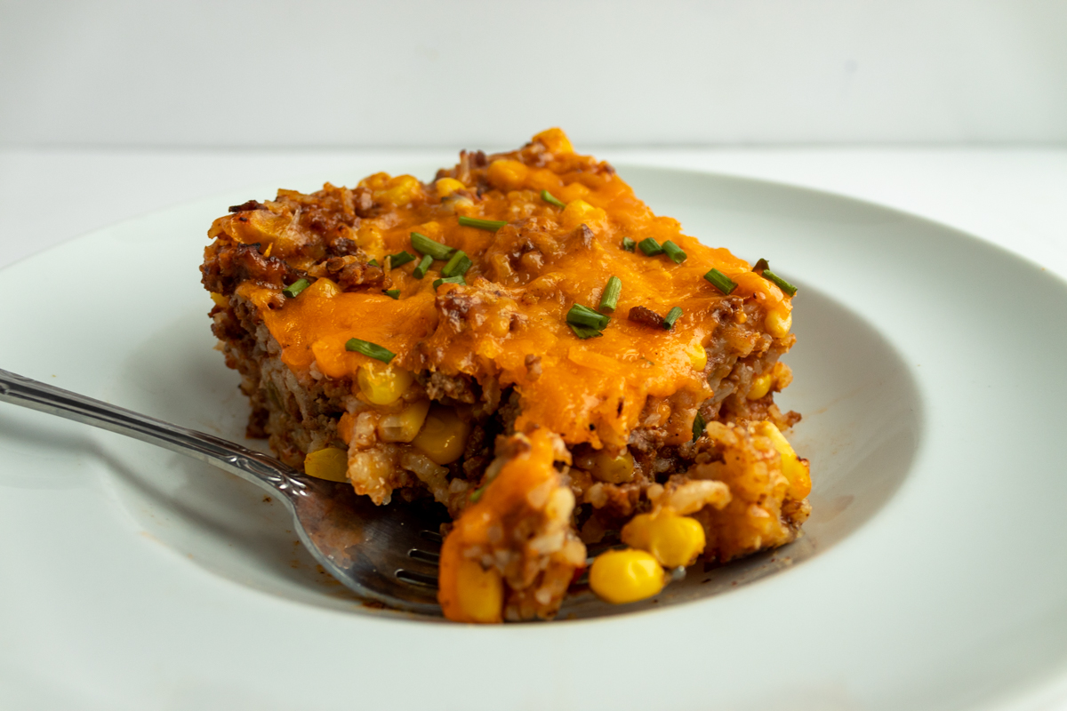 Mexican casserole on plate with fork