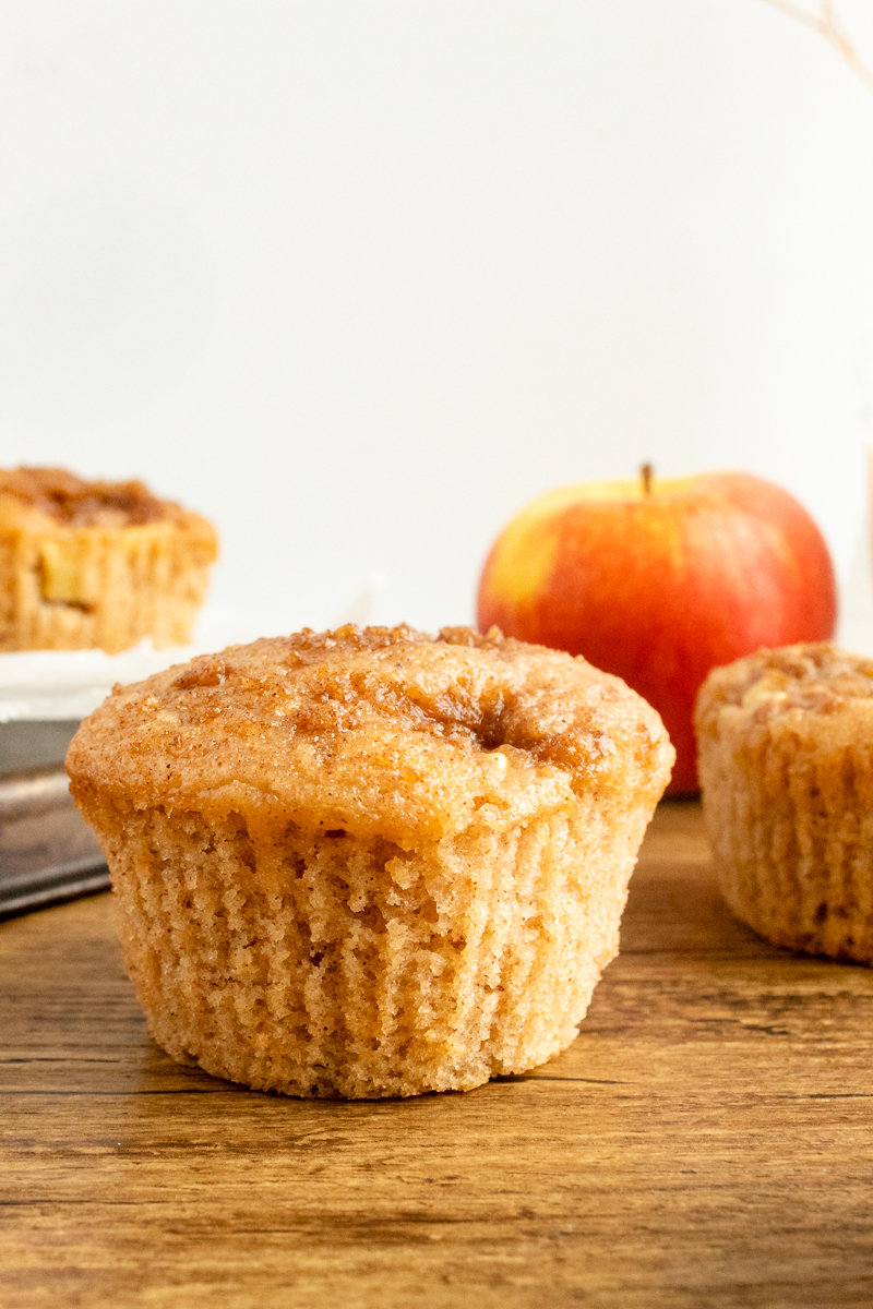 apple cinnamon muffins with apple in background