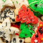 Pile of sugar cookies decorated for christmas overhead close up.