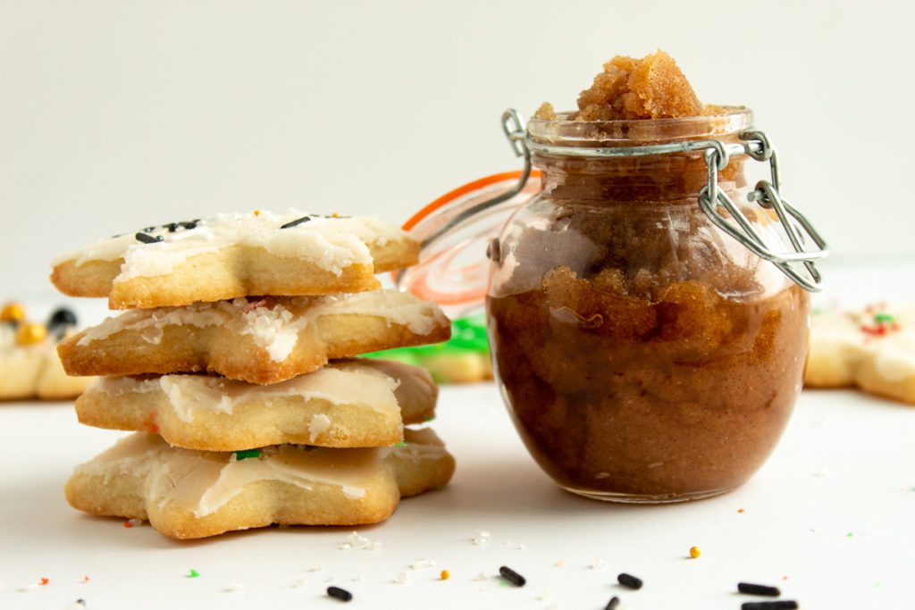 Sugar cookie body scrub in cute jar with sugar cookies surrounding