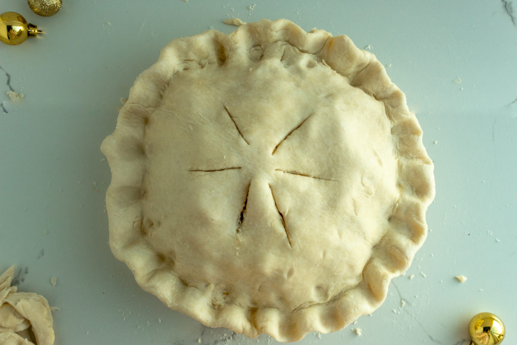 Double pie crust with fluted edge and slits on top overhead shot