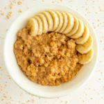 Pressure Cooker Steel Cut Oatmeal in bowl overhead shot with banana.