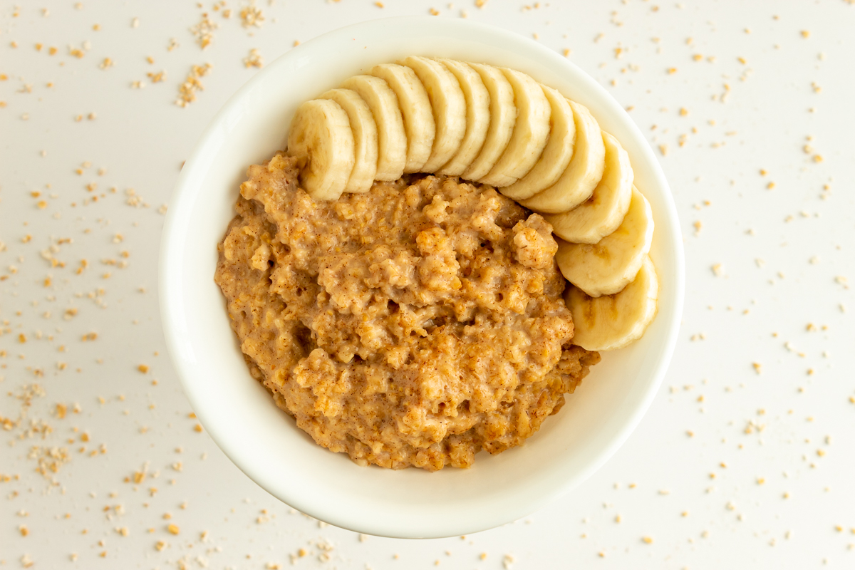 Pressure Cooker Steel Cut Oatmeal in bowl overhead shot with banana.