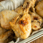 Lemon Dijon Chicken Drumsticks sitting in loaf pan with parchment paper