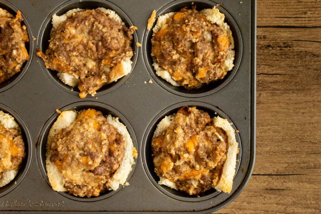 Cheeseburger cupcakes in muffin pan overhead shot