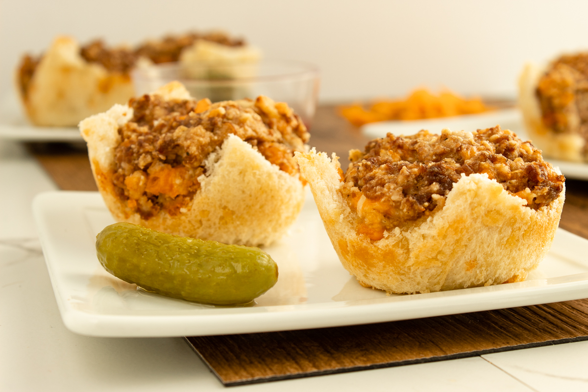 Hamburger cupcakes on plate with pickle.