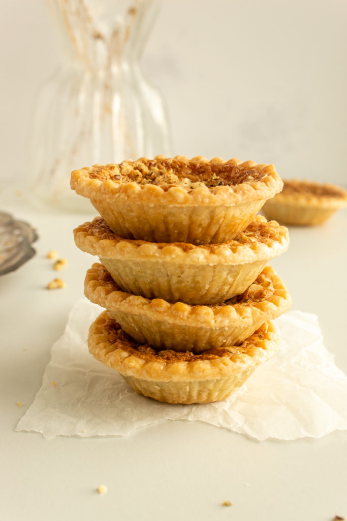 Super Easy Butter Tarts stacked on piece of parchment.