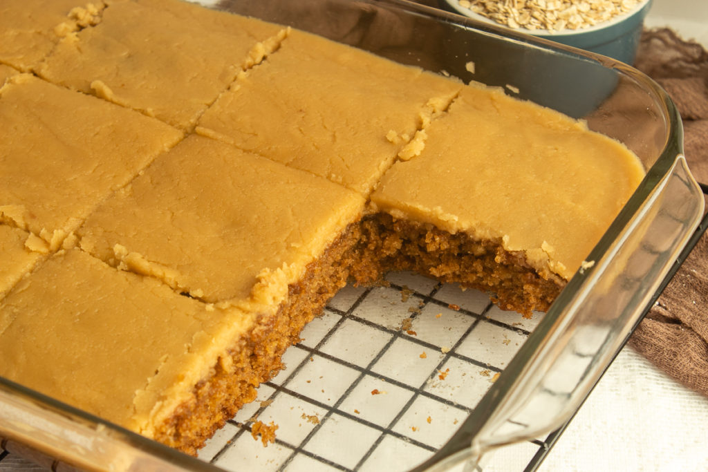 Elvis presley spice cake with brown sugar icing in glass cake pan angled shot.