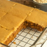 Elvis presley spice cake with brown sugar icing in glass cake pan angled shot.