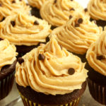 Peanut butter frosting on chocolate cupcakes angled shot.