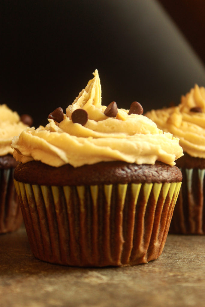 Chocolate cupcakes with peanut butter frosting dark food photography