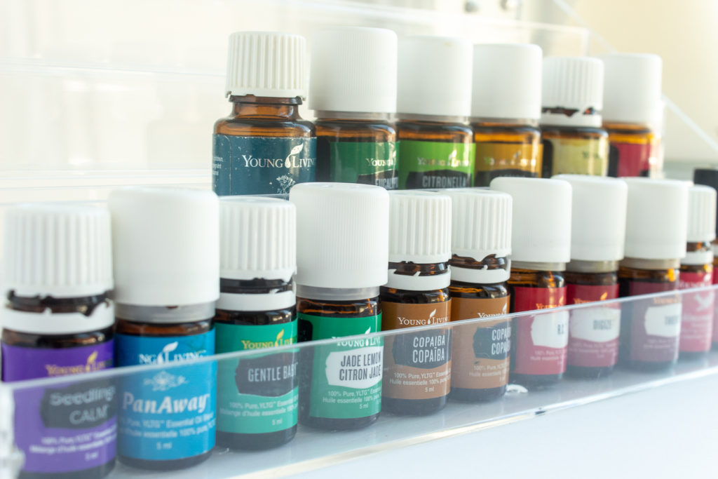 Angled straight shot of Young living Essential oils standing in clear acrylic organizer. Summer 2021 favourites.