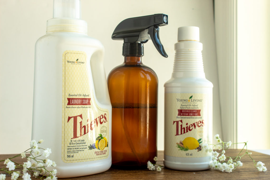 Thieves Laundry Soap beside Glass spray bottle and Thieves Household Cleaner.