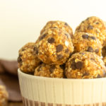 Healthy no bake energy balls in bowl straight on shot.