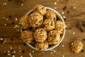 Healthy no bake energy balls in bowl overhead shot.