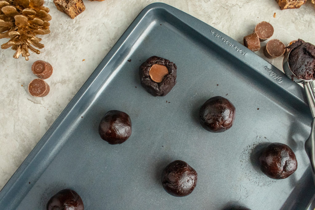 Rolo Cookie dough on baking pan overhead shot with cookie scoop.