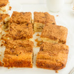 Moist Coffee Cake sliced in squares on parchment paper angled shot.