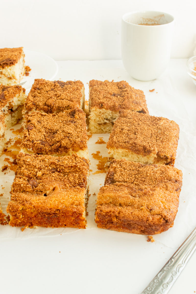 Moist Coffee Cake sliced in squares on parchment paper angled shot.