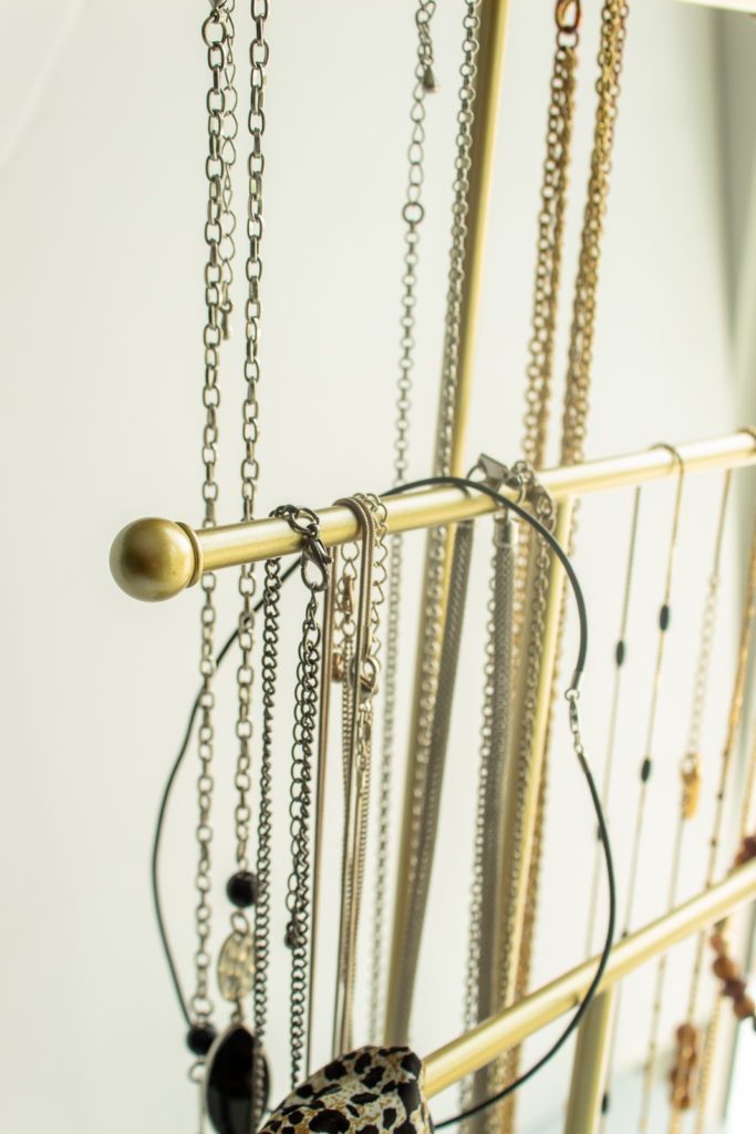 3 tier necklace organizer with necklaces.