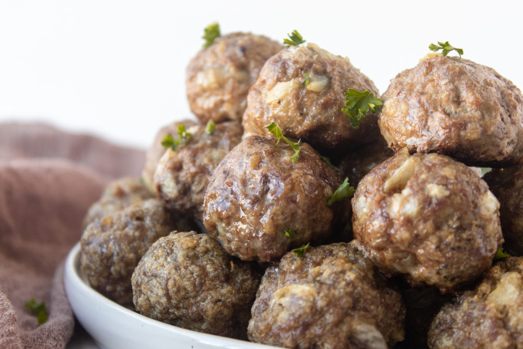 Easy Basic Meatballs stacked on plate straight on shot.