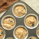 Easy Healthy Blueberry Muffin batter in muffin tin overhead shot.