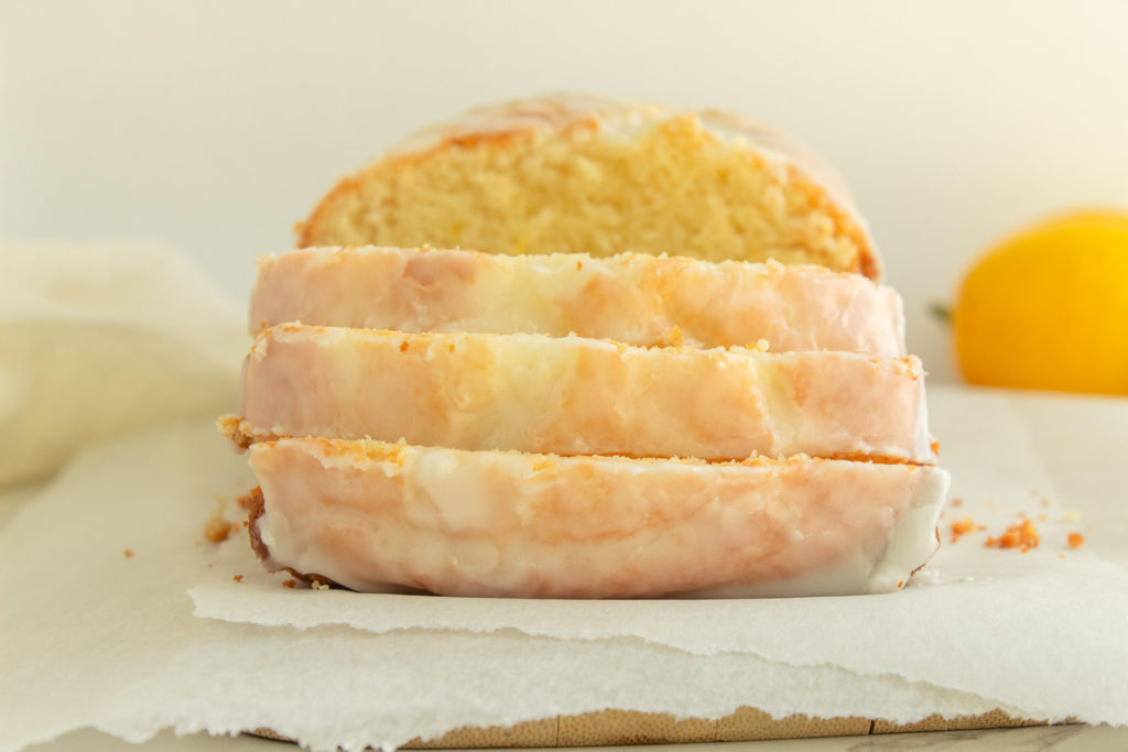 Gluten-Free Lemon Loaf recipe sliced on cutting board straight on shot.