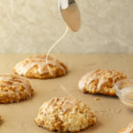 Cinnamon Bun Scones drizzle shot with spoon.