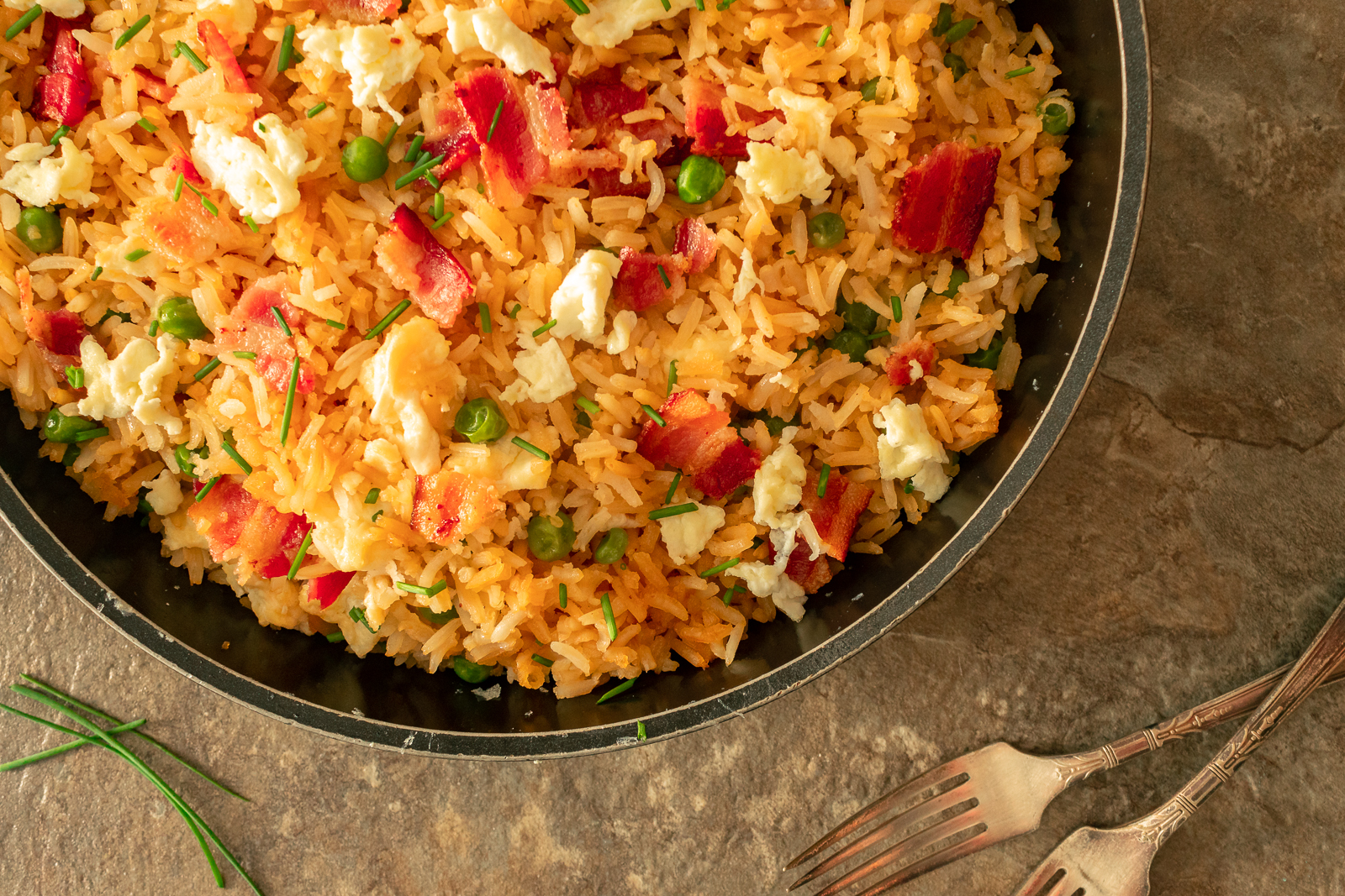 Fried rice overhead shot with 2 forks and green onions.