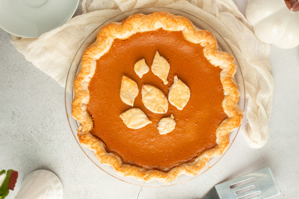 overhead shot of pumpkin pie with pie crust leaves on top.