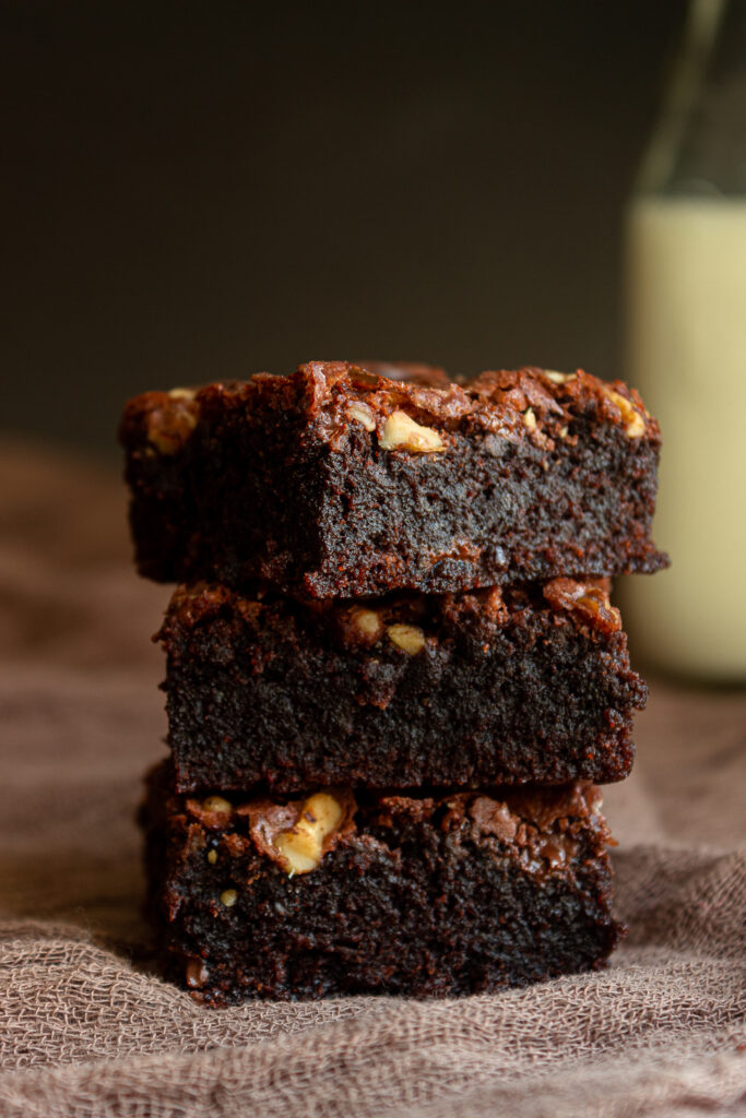 Classic brownies stacked on top of eachother straight on shot.