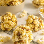 Popcorn balls old fashioned on marble surface angled shot.