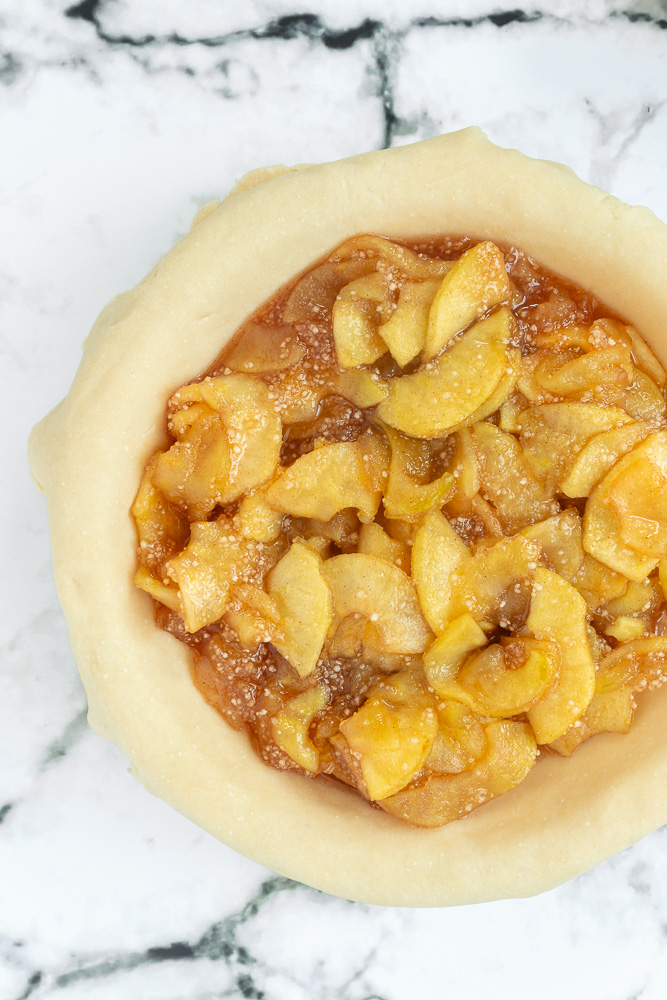 Overhead shot of Apple pie filling in unbaked pie crust.