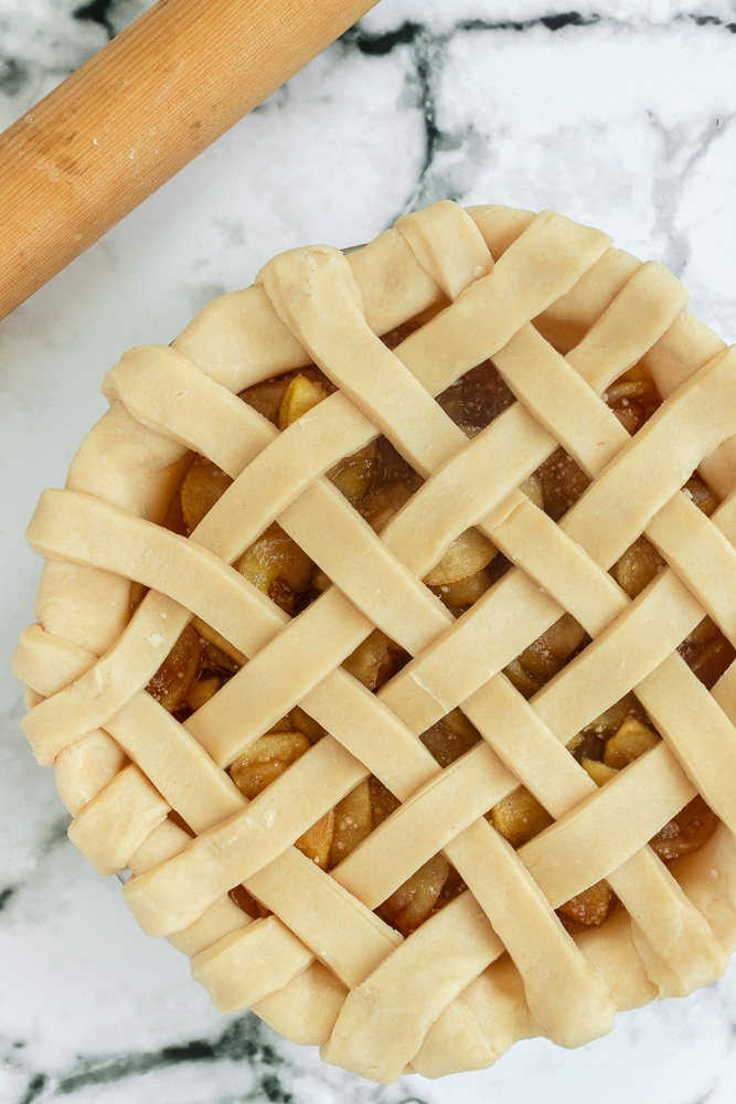 Overhead shot of Apple pie with unbaked lattice crust.