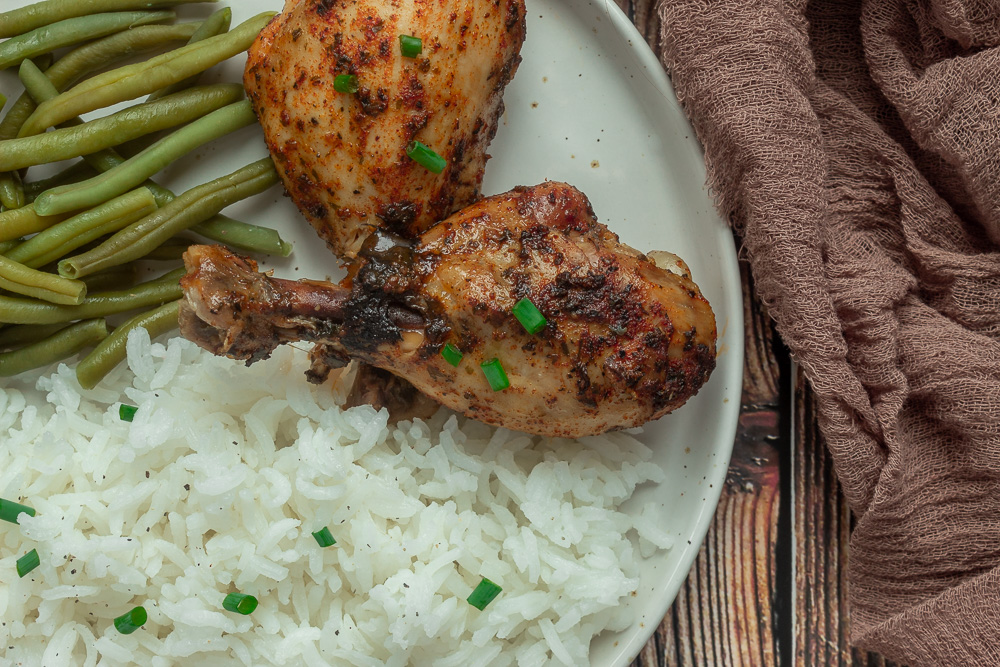 Easy Slow Cooker chicken drumsticks overhead shot with rice and green beans on plate.