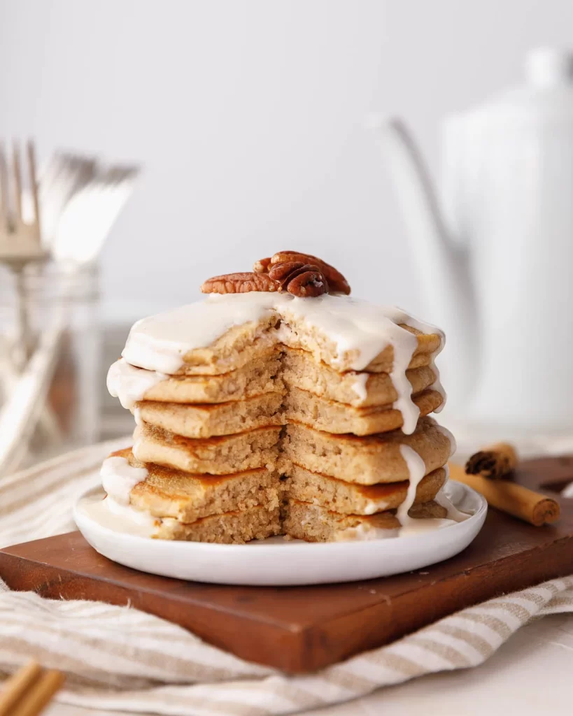 Straight shot of cinnamon brown sugar pancakes stacked on plate.