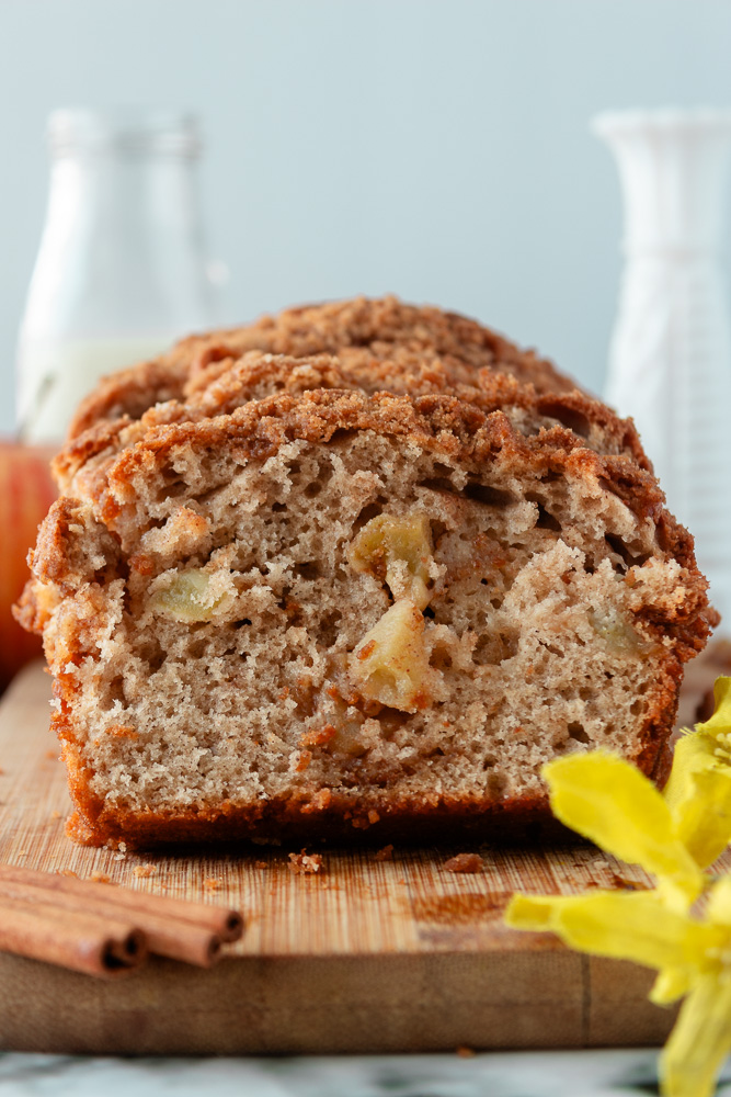 Straight on shot of Apple Cinnamon streusel bread sliced on cutting board.