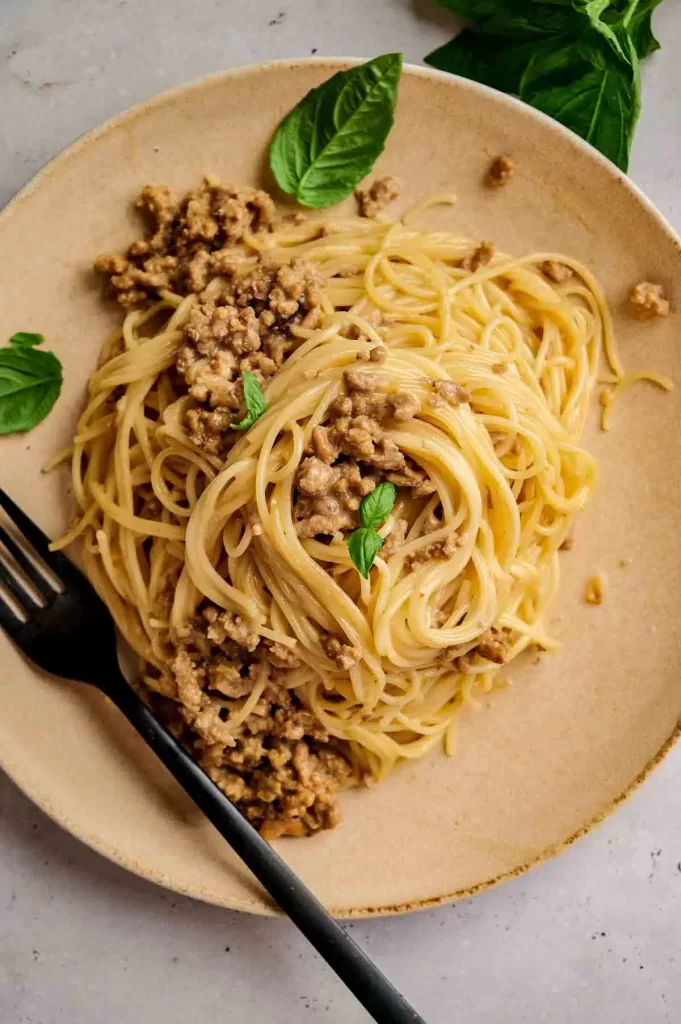 Romantic dinner recipe for two: overhead shot of beef carbonara on plate.