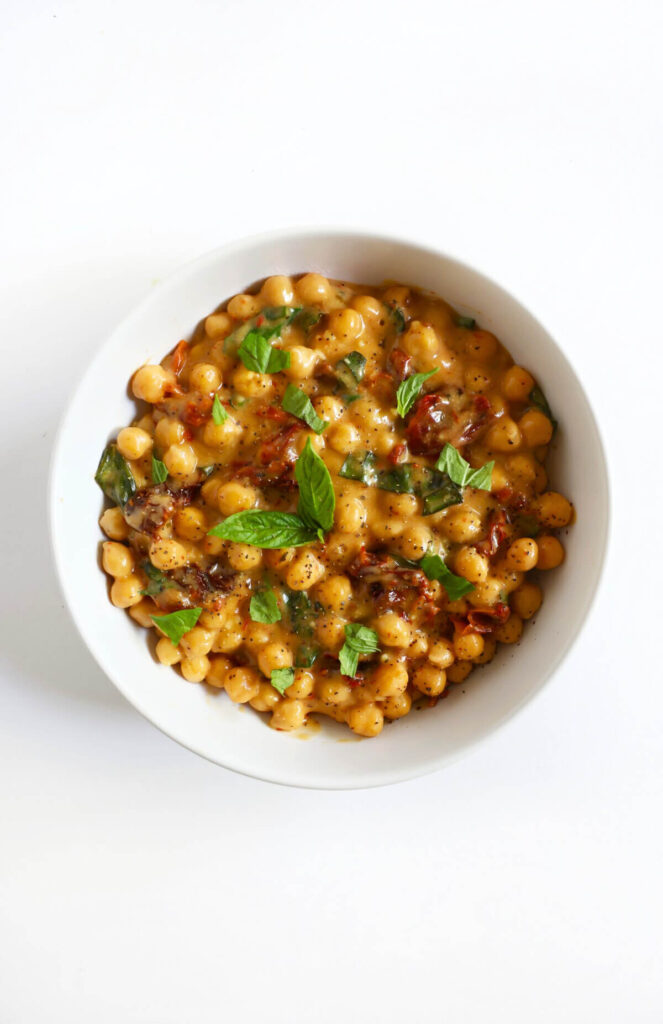 Romantic dinner recipe for two: overhead shot of marry me chickpeas in white bowl on white surface.