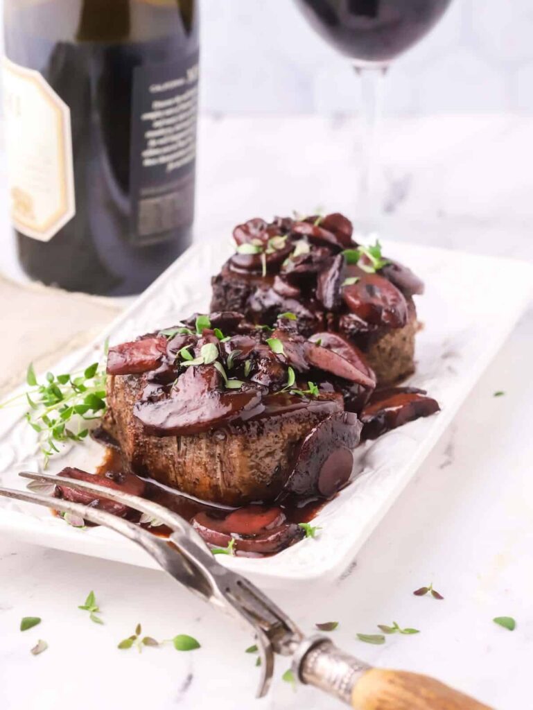 Romantic dinner recipe for two: angled shot of filet mignon in mushroom sauce.